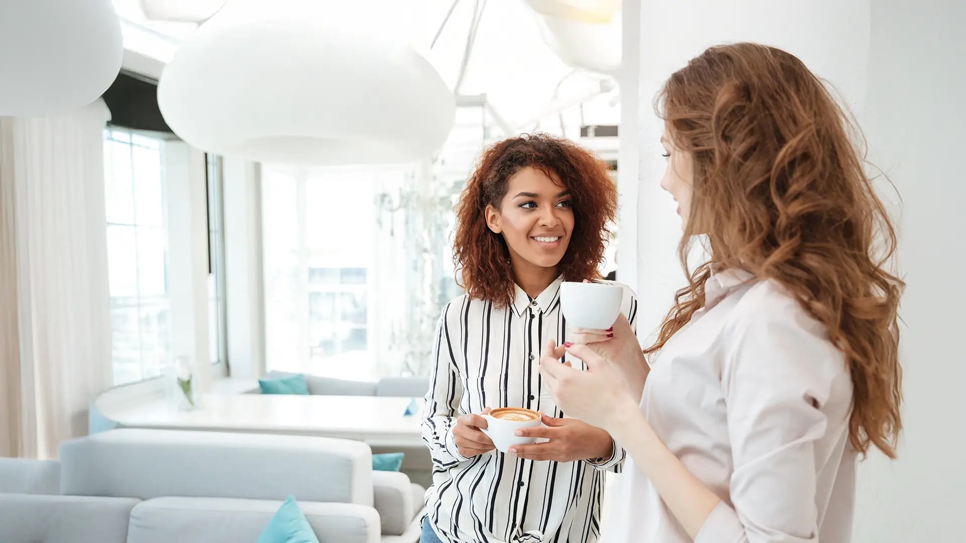 Friends smiling and drinking coffee