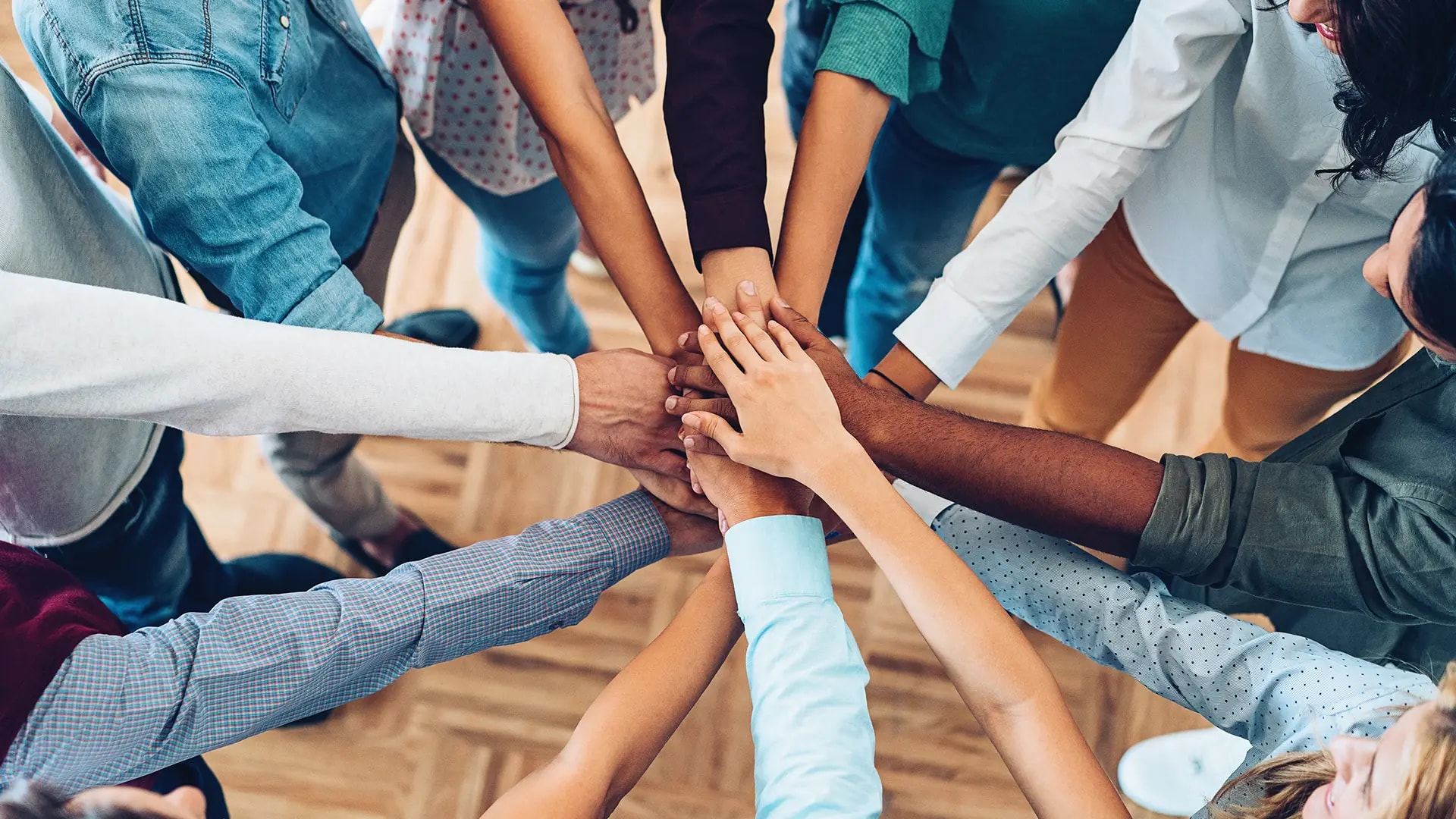 A group of people joining hands in a circle