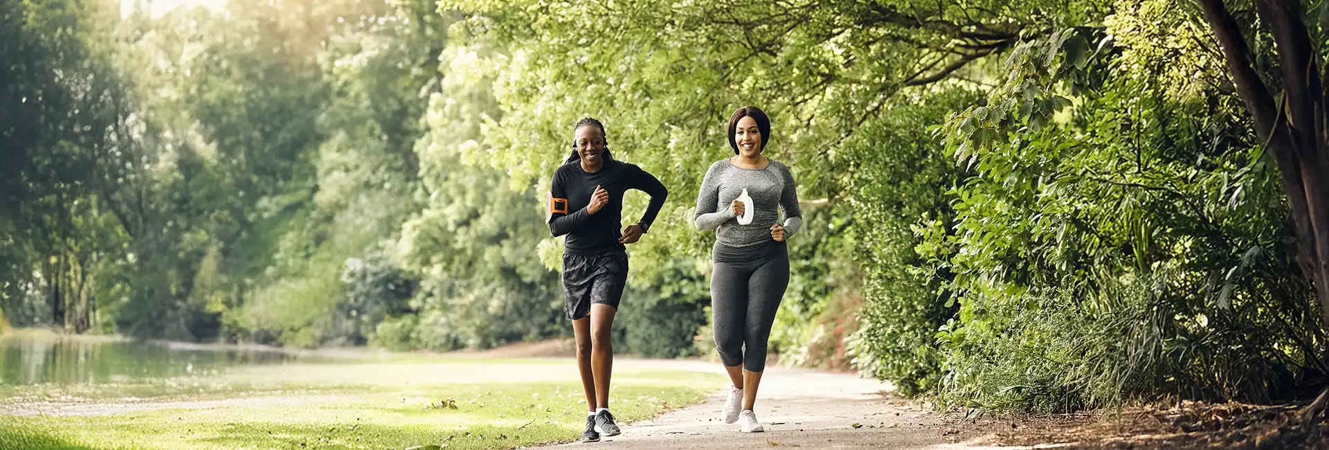 Two people running in a park
