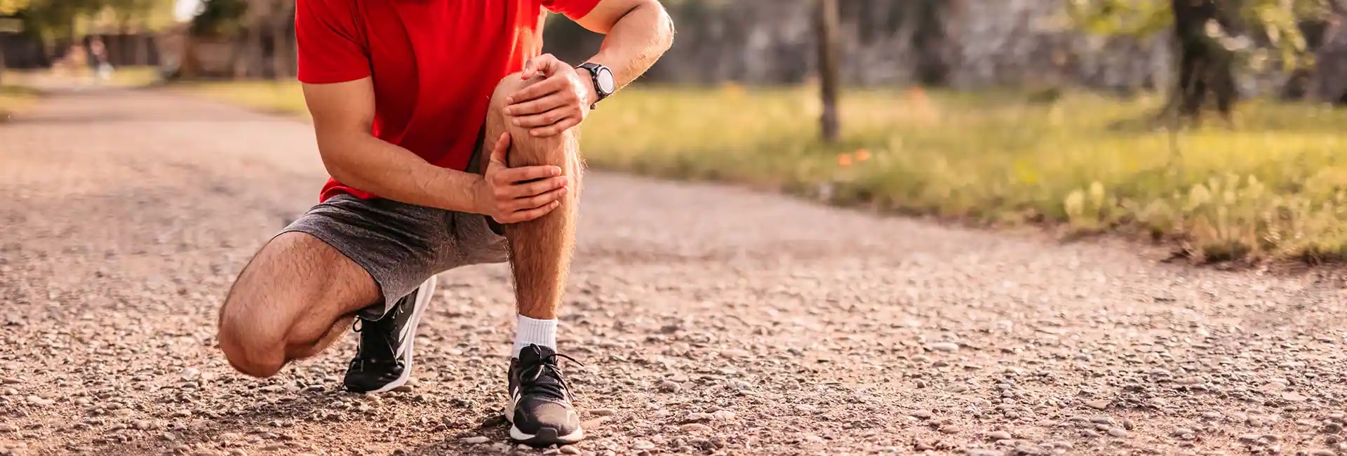 Runner holding knee in pain