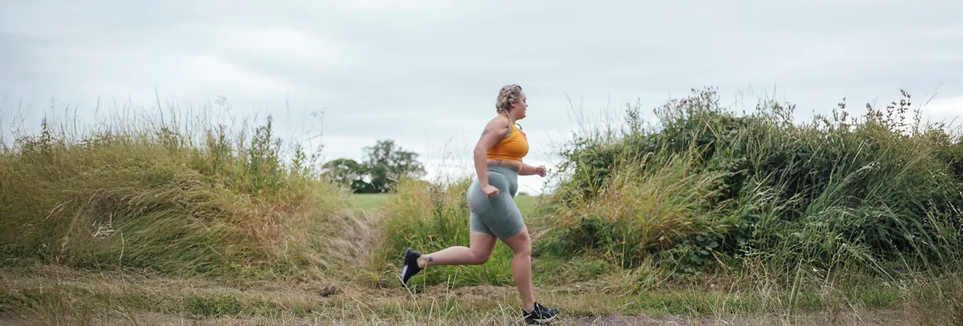 Runner jogging along a park path