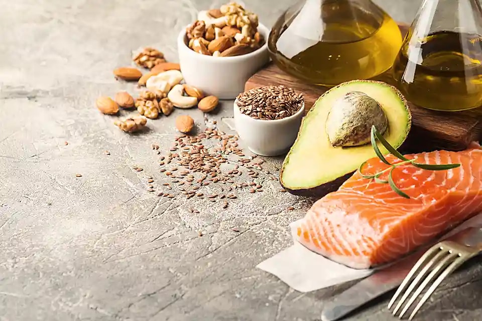 Selection of nuts, salmon, avocado and oils