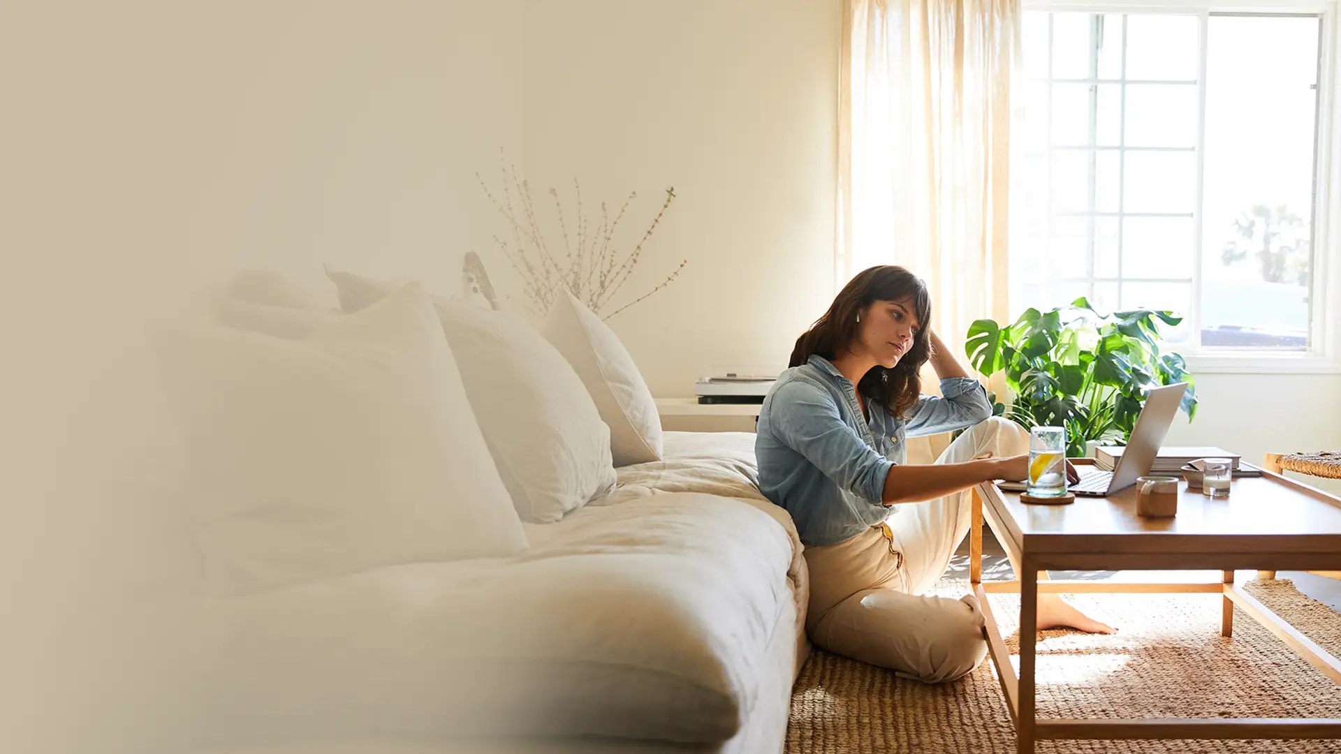 Woman sitting on the floor with a laptop
