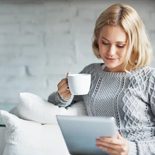 Woman with coffee and a tablet