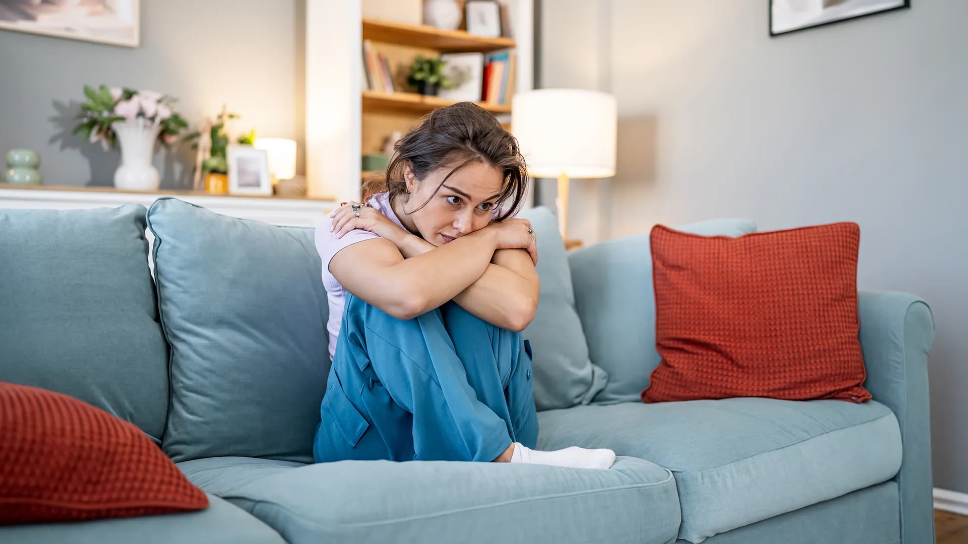 Young woman feeling sad and lonely at home